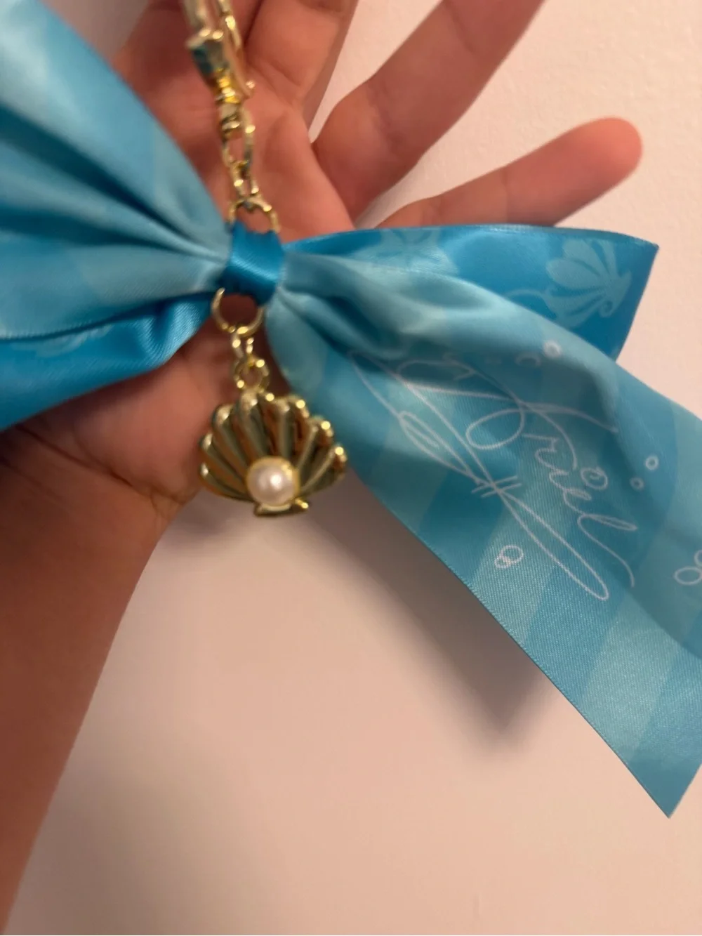 Disney Teal Ribbon Keychain with Gold Shell and Pearl Charm